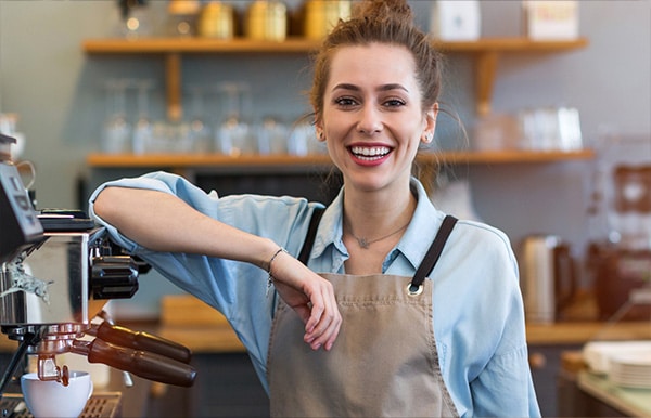 Barista leaning on coffee machine