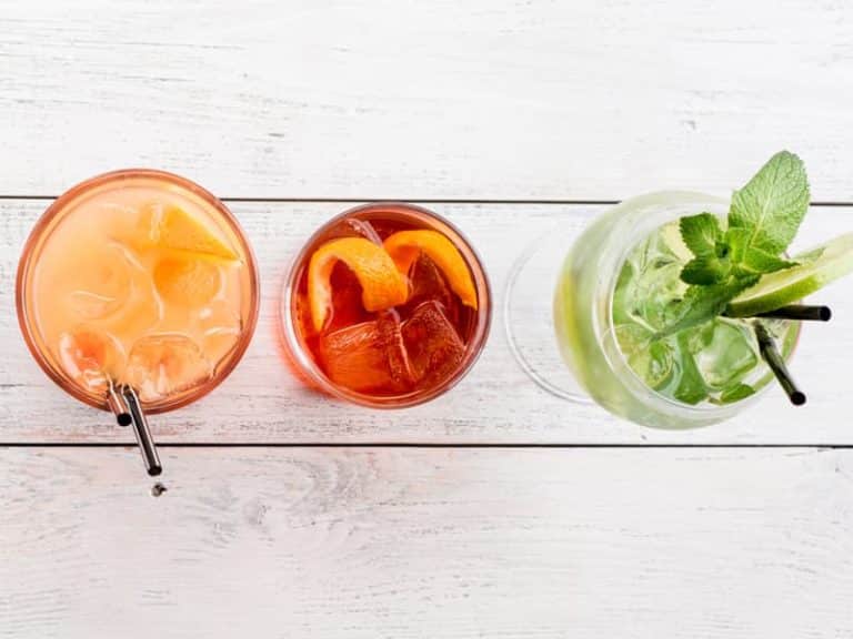 Three iced tea drinks, sat on a wooden surface