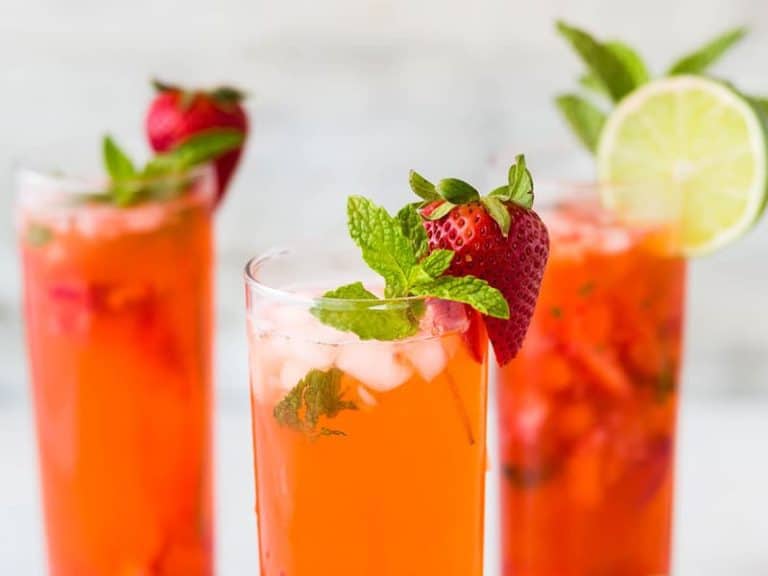 Three glasses of Finlays iced tea garnished with strawberries and lemon